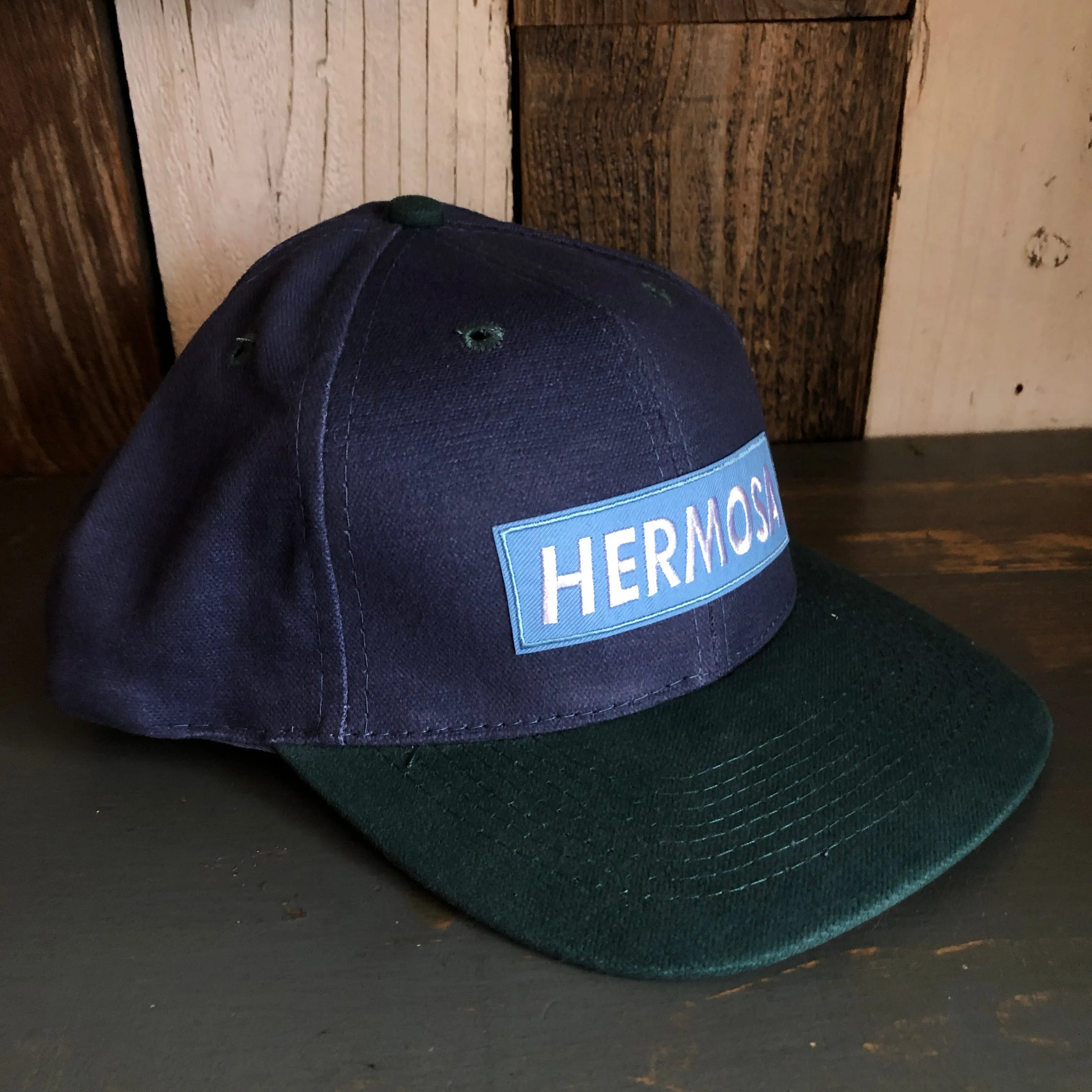 Hermosa Beach BLUE SUPREME HERMOSA - 6 Panel Low Profile Baseball Cap with Adjustable Strap with Press Buckle - Navy/Dark Green